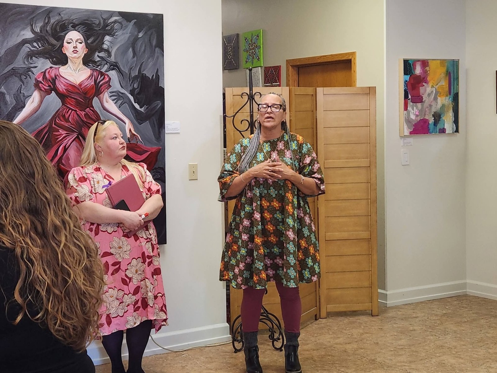 Opening remarks with The Gravity of Touch on the gallery wall behind, Arts for Vets, Grand Forks ND, March 2026. Photo by Arts for Vets.