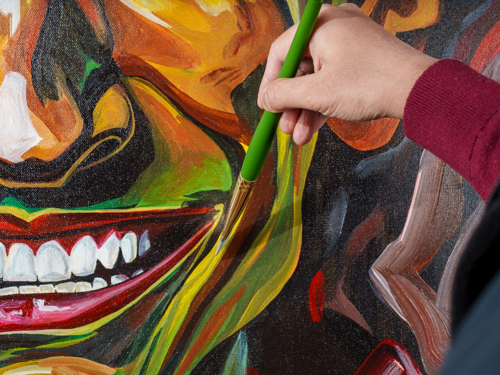 Agarwal's hand glides a fine brush along the painted teeth and jawline. Insanity, 2026, by Payal Agarwal.