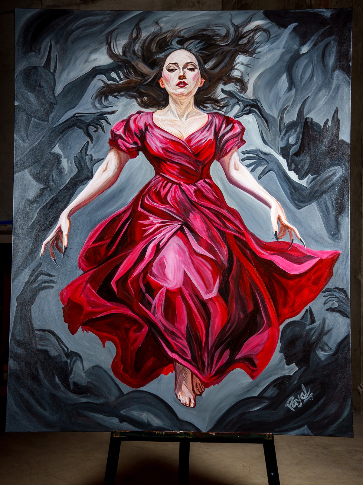The full canvas rests on an easel, the red-gowned figure suspended amid encroaching shadow hands. The Gravity of Touch, 2026, by Payal Agarwal.