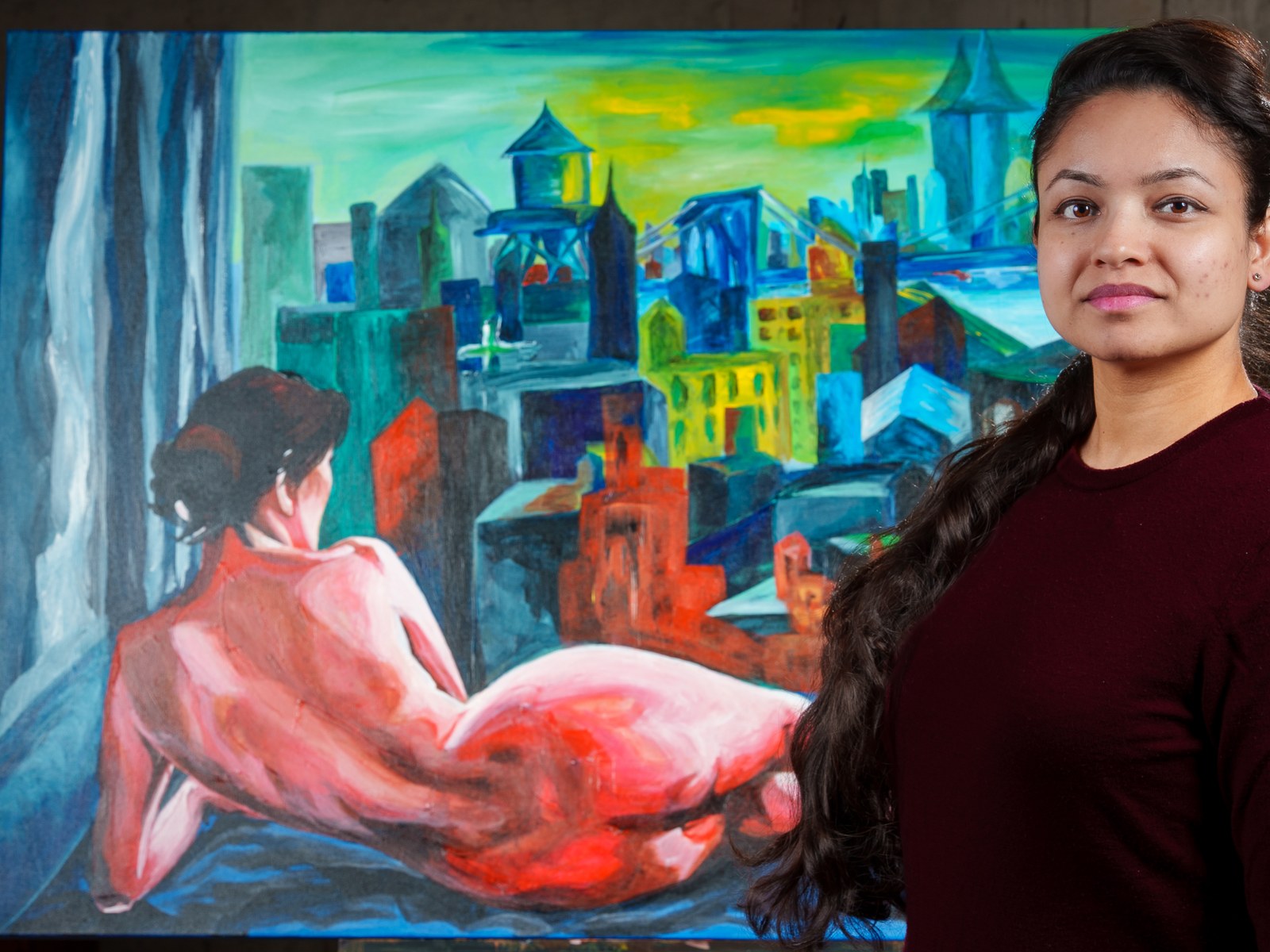 Payal Agarwal stands beside the finished canvas, her reclining figure adrift before the painted city. The Heat of Cold Distance, 2026, by Payal Agarwal.