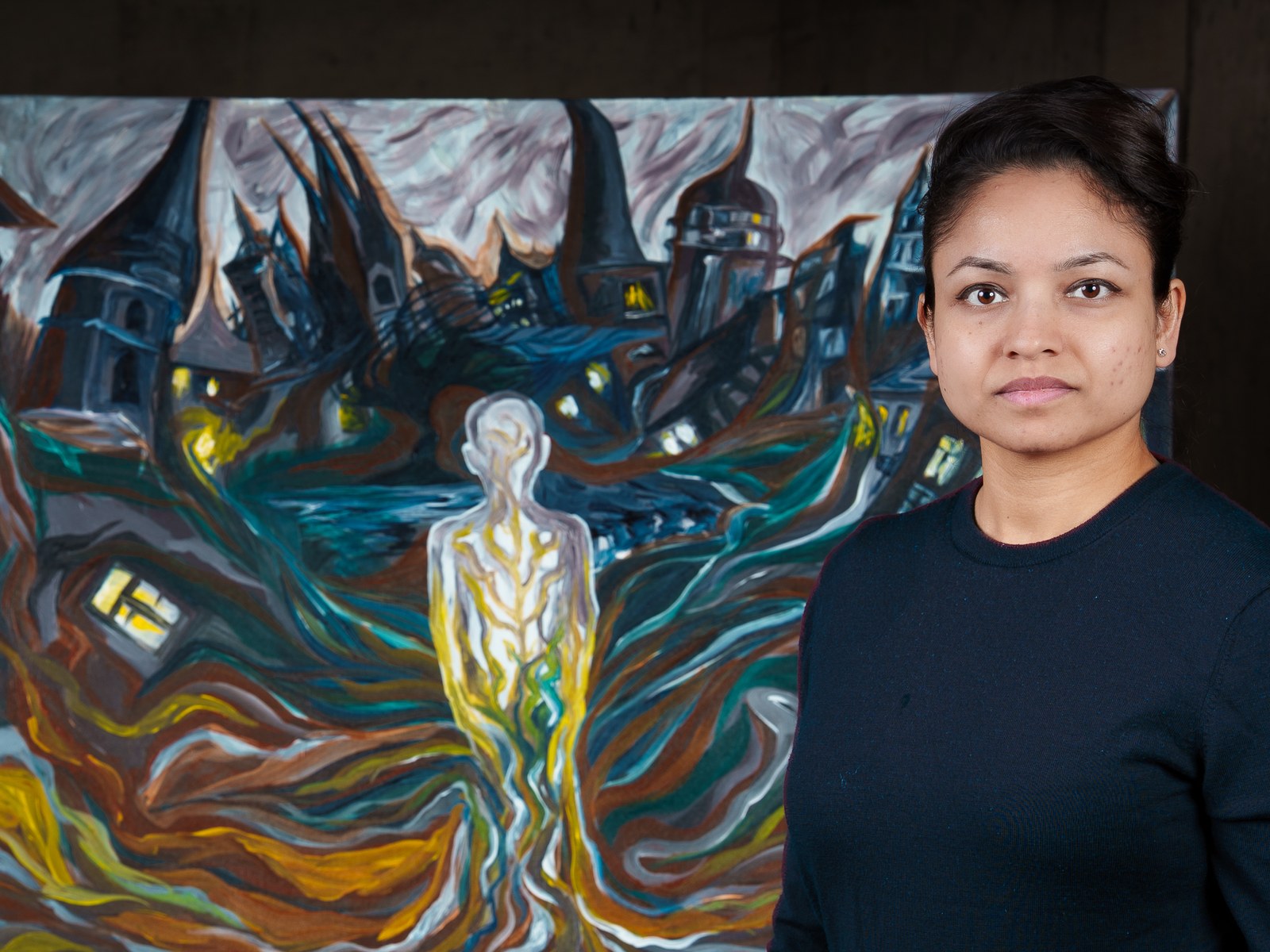 Payal Agarwal stands beside the finished canvas, composed against her swirling world. What You Root Into, Roots Into You, 2026, by Payal Agarwal.